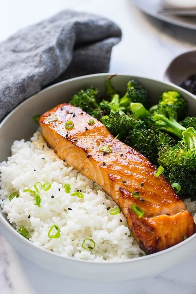 Delicious air fryer honey garlic salmon plated and garnished.