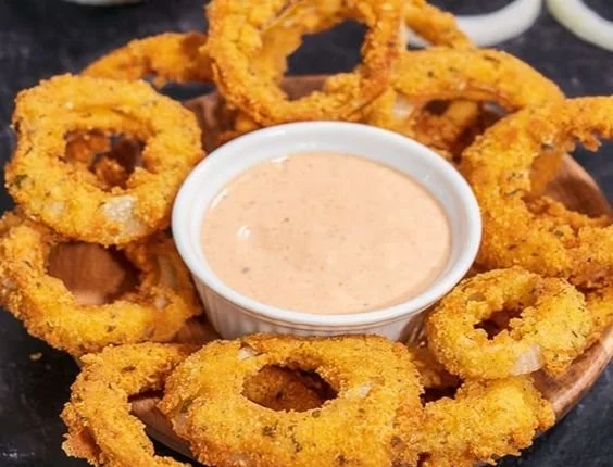 Crispy keto onion rings served with dipping sauce