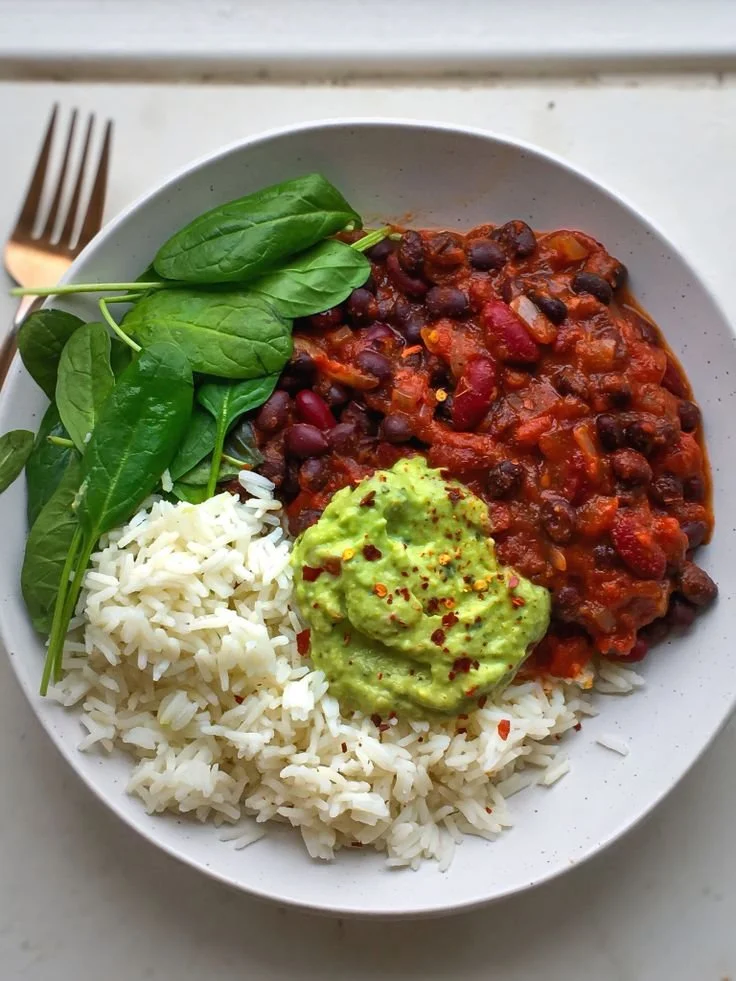 A bowl of delicious Easy Bean Chilli garnished with herbs