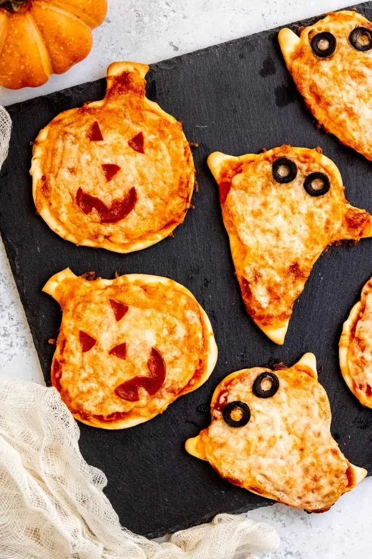 Mini Halloween pizza with spooky toppings perfect for Halloween parties.