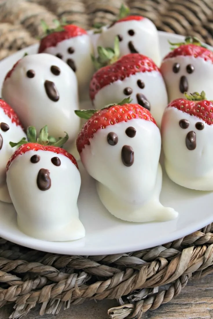 Halloween chocolate covered strawberries with ghost faces for festive treats