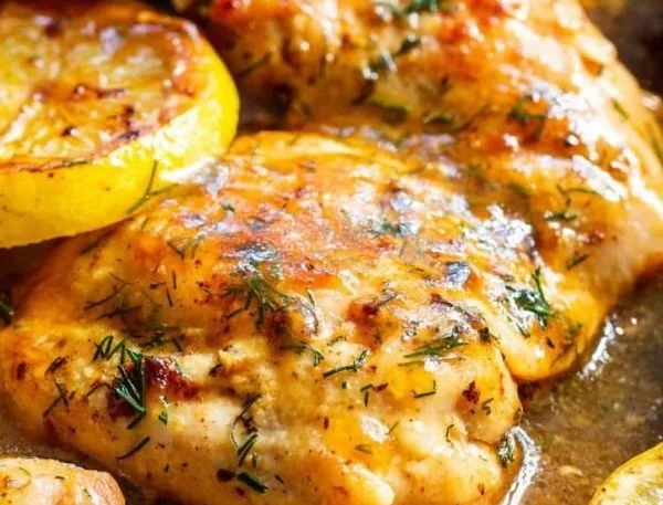 Paleo Lemon Dill Chicken served with herbs and a side of vegetables