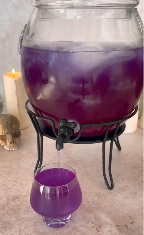 Purple Potion Punch drink with whiskey, garnished for parties and celebrations.