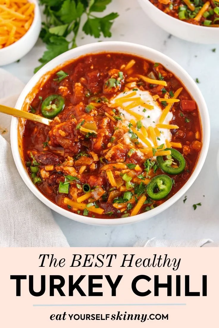 Healthy turkey chili served in a bowl with fresh herbs and spices